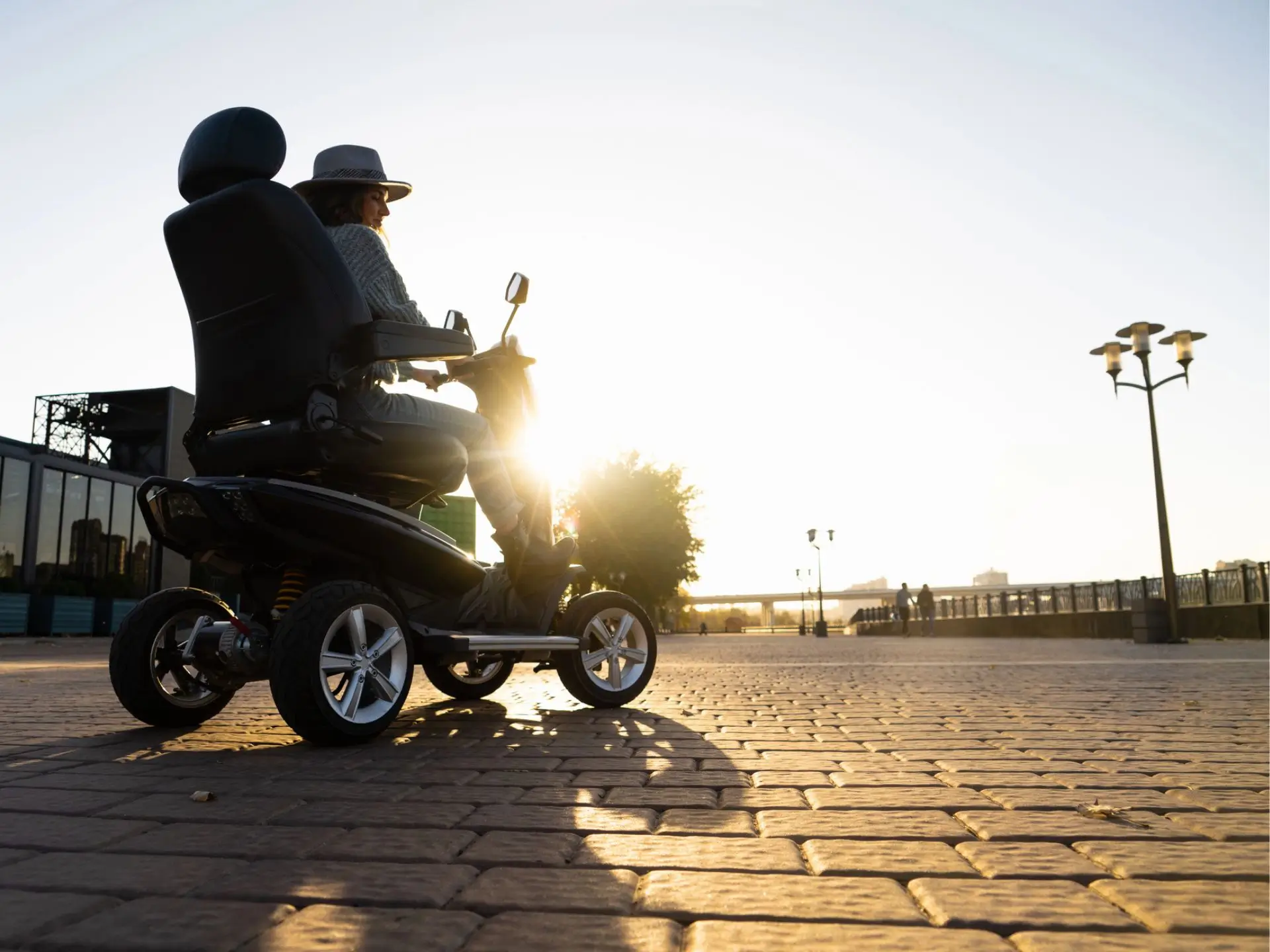 Woman riding a mobility scooter on a boardwalk